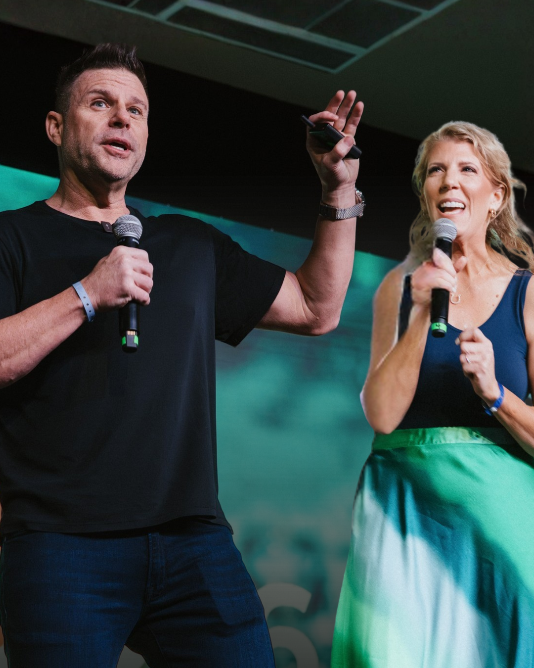 Shelley Johnson and Jay Kinder on stage at an IMPACT Worldwide event